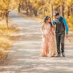 A pre-wedding shoot is like taking a walk into your future together. This cinematic shot on a quiet, tree-lined road captures the start of that beautiful journey.