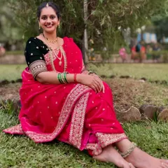 A relaxed and happy pose, showing the comfortable yet regal drape of the Nauvari saree. Perfect for enjoying long ceremonies and functions.