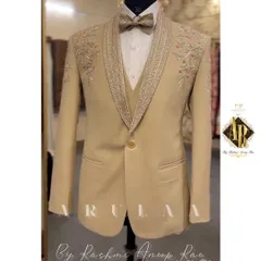 This beige three-piece suit offers a softer, elegant alternative for a day wedding or reception. The design features delicate floral embroidery on the shoulders and a richly detailed lapel, combining classic tailoring with romantic touches.