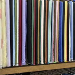 A selection of solid-colored fabrics, perfect for trousers, suits, or kurtas. I stock high-quality materials in every shade.