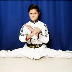 Age is just a number. This is my little master Zainul, a black belt who has achieved a level of discipline and flexibility that many adults only dream of. He shows perfect form in a full split, a testament to his dedication.
