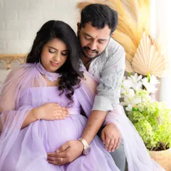 A quiet, intimate moment as the couple gently holds the baby bump. This pose beautifully captures the connection and anticipation of the parents-to-be.