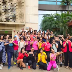 A group photo from a World Wellness Weekend event at The Ritz-Carlton, Bangalore. The heart signs say it all: these sessions are about building a positive, connected community through dance and fitness.