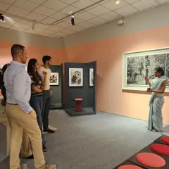 Here, one of our founders, Amrita Guha, is seen engaging with visitors at our curated exhibition. We believe in creating a dialogue, sharing the stories behind the art and design to enrich the viewer's experience.