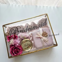 Our signature glass and brass box is the ultimate way to pop the question to your bridesmaids. It includes a personalized satin robe, a velvet jewelry case, and a custom engraved pocket mirror for a truly luxurious feel.