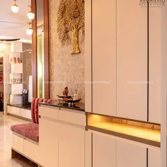 This foyer unit combines a seating bench with shoe storage and a tall cabinet, all elegantly designed with a gold tree-of-life mural as a backdrop.