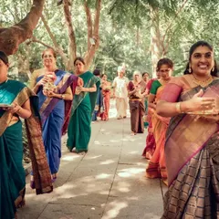 A beautiful procession of women in colorful sarees during a traditional South Indian wedding ceremony. We capture the cultural richness and vibrant details of your special day.