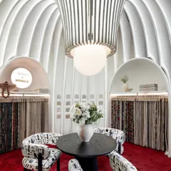 The central meeting space, framed by the soaring, illuminated fabric fins. The design creates a sense of intimacy and grandeur simultaneously, making it the perfect place to appreciate the textures and patterns of the fabrics on display.