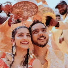 The pure, unscripted joy of a Haldi ceremony. I focus on capturing these genuine smiles and laughter as family and friends shower the couple with blessings and turmeric-infused water.