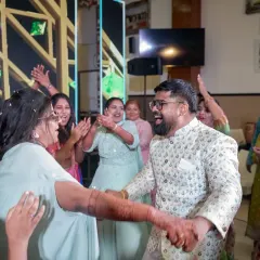 The bride and groom dancing with their family. A sangeet is all about bringing two families together, and the dance floor is the perfect place for that to happen.