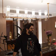 A relaxed moment with Allu Arjun during the 'Pushpa 2' promotions. The custom black Huemn hoodie is the star, combining street style with film promotion.