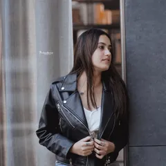 A classic street style look with a leather jacket against a modern architectural background. This shot shows how I use urban textures and lines to create a strong fashion statement.