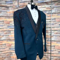 A side profile of the teal blue Indo-Western suit, highlighting the sequin work that cascades down the shoulder. This detail adds a touch of sparkle without being overwhelming, perfect for evening events.