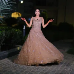 A happy and twirling bride-to-be at her engagement shoot. The full gown and elegant makeup create a fairytale moment.