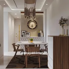 This modern dining area is designed for elegant meals and conversations. A statement chandelier hangs over a sleek marble-top table, surrounded by contemporary wooden chairs. The design balances luxury with a clean, open layout.