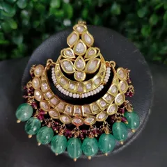 A close-up of a beautiful chandbali earring with kundan work and green bead drops. This piece from my rental collection is both traditional and stylish.