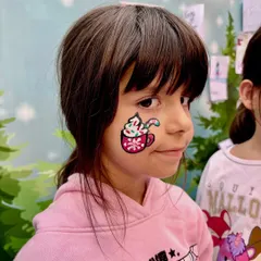 Getting into the holiday spirit with a festive hot cocoa design on the cheek. This is a great example of detailed cheek art that adds a touch of Christmas magic to any event.