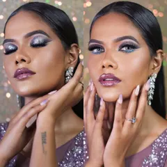 A glamorous party look with silver glitter eyeshadow and a glossy mauve lip. This demonstrates the premium product workshop where students learn to create sparkling, high-impact looks for evening events.