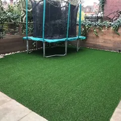 A perfect example of a family-friendly backyard. This durable artificial lawn provides a safe and soft surface for a trampoline and daily play, without the worry of mud, patches, or constant upkeep.