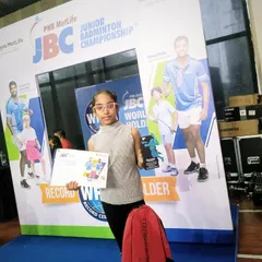 Akshita proudly displays her trophy and certificate after a strong performance at the PNB Metlife JBC Badminton Championships, where she also defeated the top-seeded player.