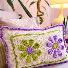 Bright blooms and soft textures make this crochet cushion cover a happy addition to any room. The flower power squares in moss green and purple bring a playful, charming touch to your cozy corners.
