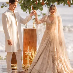 A joyful moment on the beach. The bride's lightweight lehenga was perfect for the seaside setting, allowing for beautiful movement, while the groom's classic sherwani was both elegant and comfortable.