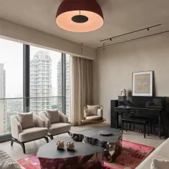 For the East Coast Residence, we created a dynamic living space with a view. The unique, metallic-finish coffee tables contrast with the soft textures of the rug and seating, while a playful swing adds a personal touch.