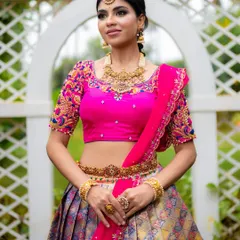 For ethnic wear brands, I focus on capturing the richness of the fabric and the intricacy of the design. This full-length shot of a Kanjeevaram half saree uses bright, natural lighting to make the vibrant pink blouse and detailed embroidery pop, perfect for a designer lookbook.