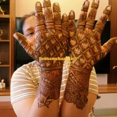 A beautiful full-hand design with a traditional jaali or checkered pattern. This style is very popular for brides and festivals.