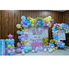 A magical unicorn theme for Jinisha's 5th birthday. This setup uses a pastel rainbow of balloons, unicorn and rainbow foil balloons, and a custom backdrop to create an enchanting party atmosphere.