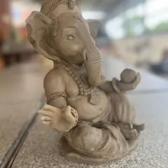 A close-up of a beautifully detailed Ganesha idol, complete with a modak, made in my studio. I find so much peace in sculpting these forms every year.