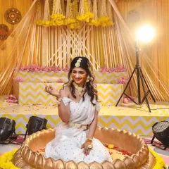 It was pure joy creating this Haldi ceremony decor for actress Aditi. I designed a beautiful setup with a custom lotus-shaped uruli, surrounded by traditional marigold flowers and a vibrant yellow and white backdrop for a festive and happy celebration.