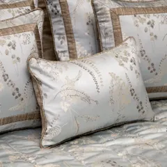 A close-up of a pillow from our Essential Grey Jacquard Bed Cover set. The rich jacquard weave and nature-inspired botanical design add a touch of refinement to your bedroom.