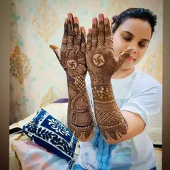 The client showing off her festive swastika mehandi, a perfect choice for religious ceremonies and festivals.