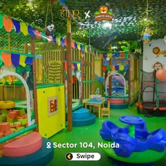 Another wide shot showing the different zones of our playground, including the foam pit, trampoline, and merry-go-round, all decorated with a fun jungle theme.