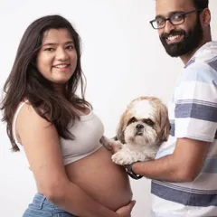 Fur babies are family too. This adorable portrait includes the couple's beloved dog, making it a complete and heartwarming family photo.