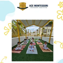 A group of children sits in a meditative pose during yoga class. These moments of quiet and focus are just as important as active play.