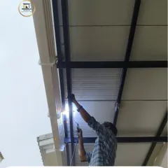 A glimpse into our on-site work. A welder carefully joins the metal frame of a puff sheet pergola, showcasing the skilled craftsmanship that goes into ensuring every structure is strong and secure.