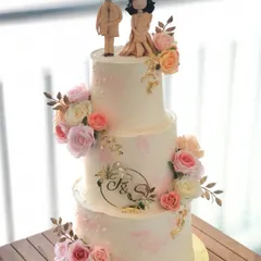 A three-tiered engagement cake for a beautiful new beginning. I designed this piece with delicate blush tones, fresh flowers, and custom fondant toppers of the couple.