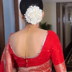 The quintessential bridal bun. A sleek, clean bun adorned with a full gajra of fresh white flowers is a timeless and elegant choice that pairs beautifully with a traditional saree.