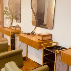 Our styling stations are designed with both comfort and elegance in mind. The blend of natural wood, soft lighting, and ergonomic chairs creates a perfect space for your hair care rituals.