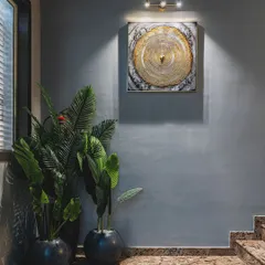 A simple track light is used here to perfectly highlight a piece of art. This is a great example of accent lighting, drawing attention to the features you want to showcase.