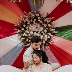 A sweet, quiet moment amidst the colorful chaos of a carnival-themed Sangeet.