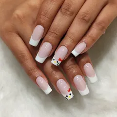 A touch of cuteness with these Hello Kitty inspired nails. I combined a classic French manicure on square-tipped nails with an adorable, hand-painted Hello Kitty accent.
