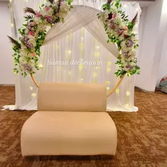 A centered view of the floral hoop backdrop, showing the comfortable seating provided for photos.