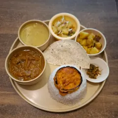 This is our Axomia style Chicken Thali. It comes with fragrant Joha rice, our classic dal, aloo pitika (mashed potato), begun bhaja (fried brinjal), and a spicy jola bota chutney. It’s a taste of a traditional Assamese home.