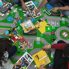 The building floor is where the magic happens. Here, participants in our LEGO Mindgym workshop sort through trays of bricks, planning their next masterpiece on a fun, city-themed play mat.