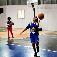 Our girls program is in full swing. Here, a player practices a left-handed layup, showcasing the ambidextrous skill development we encourage in all our athletes.