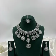Get that brilliant diamond look for your cocktail party or reception. This silver-finish necklace set is crafted with high-quality stones that catch the light beautifully, giving you a glamorous and modern style. It’s perfect for western gowns and contemporary lehengas.