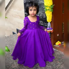Purple reign. 💜 This custom full-length purple gown is perfect for a birthday princess. The simple silhouette is elevated with delicate embroidery on the bodice and sheer long sleeves for a touch of elegance.